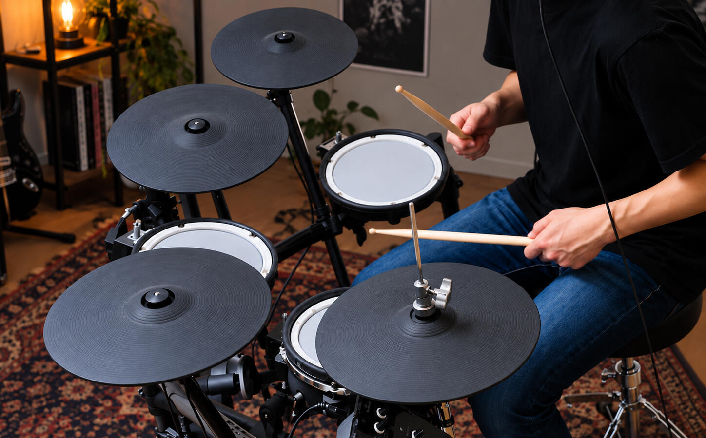 Playing an electronic drum kit at home A drummer seated at a mesh-head electronic drum kit in a living room, sticks mid-stroke over the snare and hi-hat.